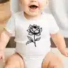 Baby Wearing A White Onesie With A Black Floral Design.