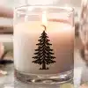 Lit Candle In A Glass Jar With A Black Evergreen Tree Design.