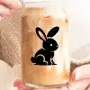 A Glass Of Iced Coffee With A Black Bunny Silhouette Design.