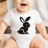 Baby Wearing A White Bodysuit With A Black Rabbit Design.