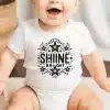 Baby Wearing A White Onesie With Shine Bright Text And Stars.