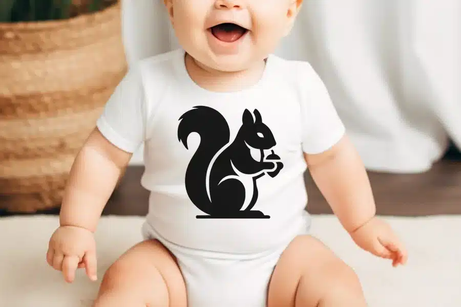 Baby wearing a white onesie with a black squirrel graphic.