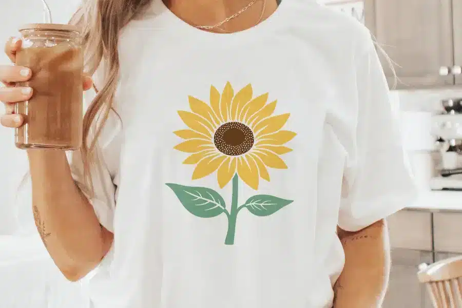 Woman wearing a white t-shirt with a sunflower graphic.
