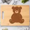 Bamboo Cutting Board With A Brown Teddy Bear Design.