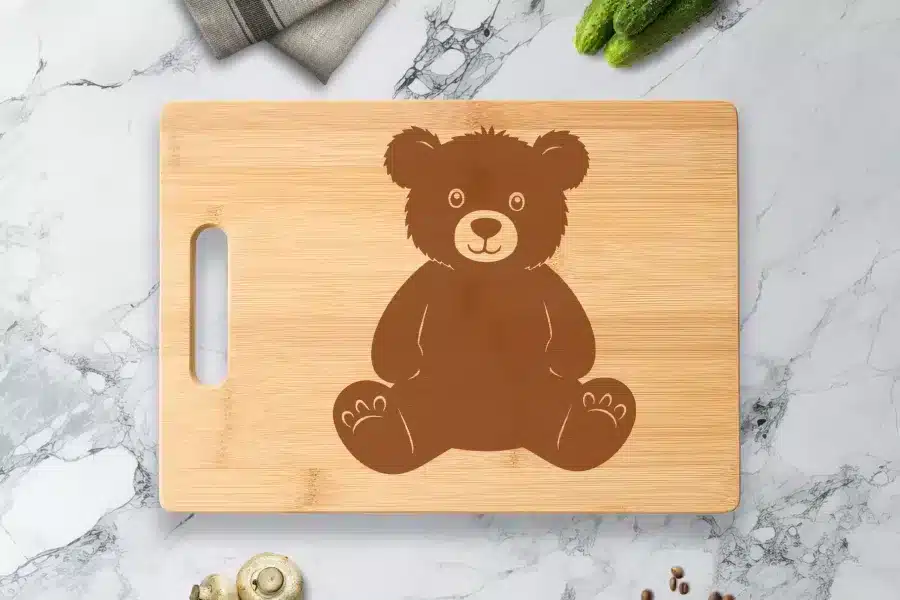 Bamboo Cutting Board With A Brown Teddy Bear Design.