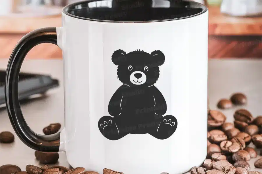White Coffee Mug With Black Handle, Featuring A Black Silhouette Of A Teddy Bear.