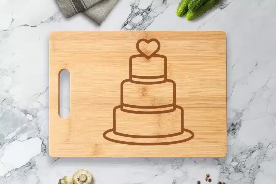Bamboo Cutting Board With Engraved Three-Tiered Wedding Cake Design.