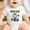 Baby Wearing A White Bodysuit With A Bunny Graphic And The Text You Got This.
